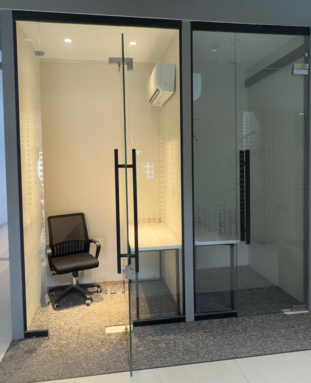 Interior view of private work cabin at Silicon Village Smart City Capital with desk, chair, and minimal workspace setup