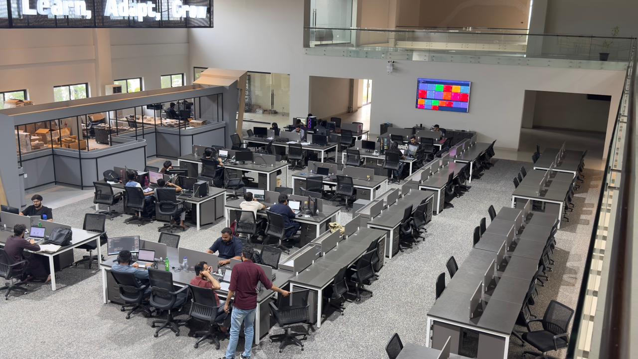 Interior view of open workspace at Silicon Village Smart City Capital with employees working at shared desks