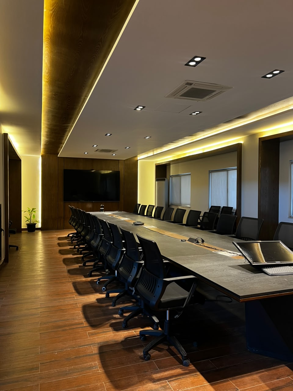 Alternate view of meeting room at Silicon Village Smart City Capital with conference table, chairs, and clean office interior design